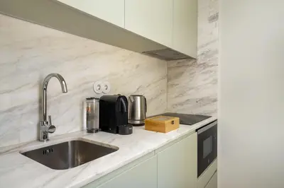 a kitchen counter with a sink and a microwave at WHome Timeless Luxury Porto w/ AC & Elevator in Porto