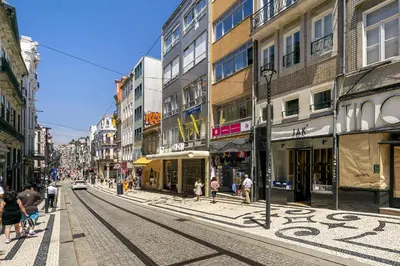 a city street with buildings and people walking on the street at WHome Timeless Luxury Porto w/ AC & Elevator in Porto