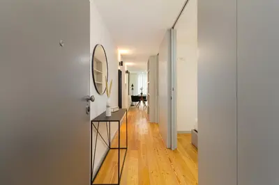 a hallway with a mirror and a table in a room at GuestReady - Cozy Vitoria Apartment in Porto