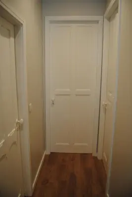 an empty hallway with a white door and wooden floors at Gaia Loves You - Serra do Pilar in Vila Nova de Gaia