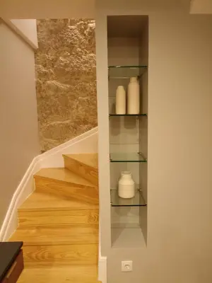 a staircase with white vases on glass shelves at Gaia Loves You - Jardim do Morro in Vila Nova de Gaia