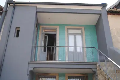 a house with a balcony and a door at Gaia Loves You - Ponte D. Luis in Vila Nova de Gaia