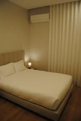 a bedroom with a white bed and a window at Gaia Loves You - Ponte D. Luis in Vila Nova de Gaia
