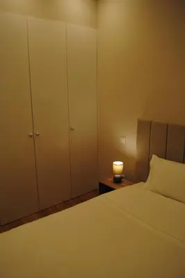 a bedroom with a bed and a night stand with a candle at Gaia Loves You - Ponte D. Luis in Vila Nova de Gaia