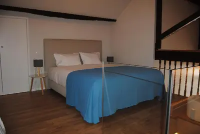a bedroom with a bed with a blue blanket at Gaia Loves You - Ponte D. Luis in Vila Nova de Gaia