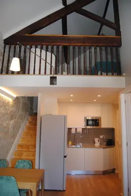 a kitchen with a staircase and a white refrigerator at Gaia Loves You - Ponte D. Luis in Vila Nova de Gaia