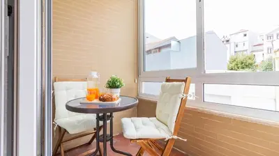 a small balcony with a table and two chairs at Urban Retreat Porto by LovelyStay in Porto