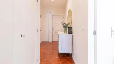 a hallway with a mirror and a counter with a sink at Urban Retreat Porto by LovelyStay in Porto