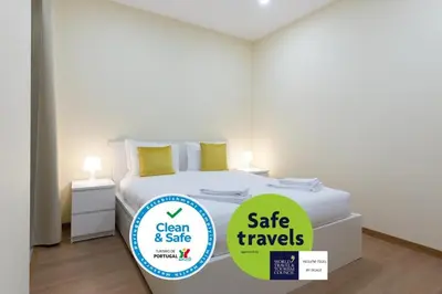 a bedroom with a bed with a sign that says clean andsafe travels at OPO Santa Catarina in Porto