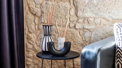 two vases sitting on a table next to a wall at Premium Duplex in Bonfim by LovelyStay in Porto