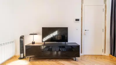a living room with a tv and a table at Premium Duplex in Bonfim by LovelyStay in Porto