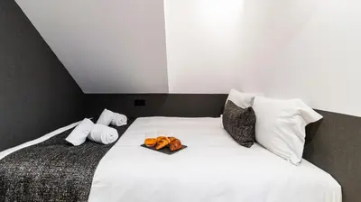 a bedroom with a white bed with towels on it at Premium Duplex in Bonfim by LovelyStay in Porto
