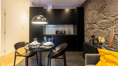 a kitchen and dining room with a table and chairs at Luxury Oasis in Bonfim by LovelyStay in Porto