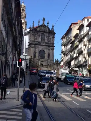 a group of people crossing a city street with an old building at Porto Chique AL 2 in Porto