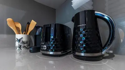 two black appliances sitting on top of a counter at Premium 2BR Flat near Santa Catarina by LovelyStay in Porto