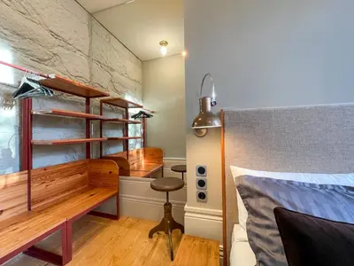 a bedroom with a bed and a desk and a chair at Victoria House in Porto