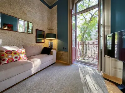 a living room with a couch and a large window at Victoria House in Porto