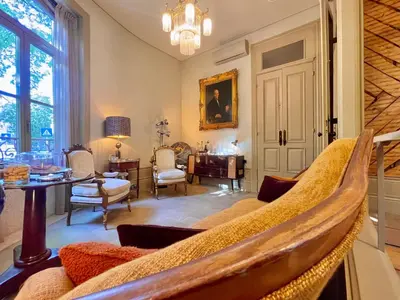 a living room with two chairs and a table and a window at Victoria House in Porto