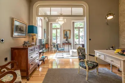 a living room with a desk and chairs in it at Victoria House in Porto