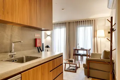 a kitchen with a sink and a living room at AVUS M Suites and Apartments by DA'HOME in Porto
