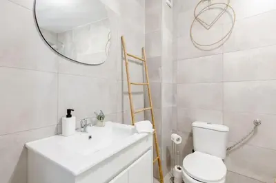 a bathroom with a toilet and a sink and a mirror at River Fleat 0 - Heart of Porto in Porto