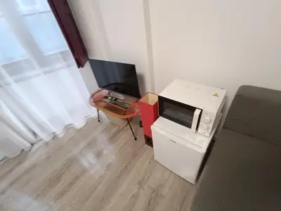 a room with a microwave and a table with a television at River Fleat 0 - Heart of Porto in Porto