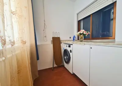 a laundry room with a washing machine and a window at Alegria Stay in Porto