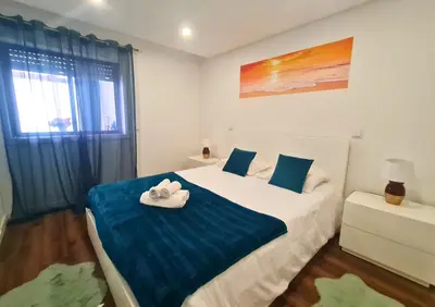 a bedroom with a bed with two towels on it at Alegria Stay in Porto