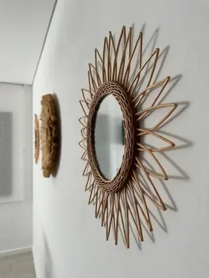 a sunburst mirror on a wall in a room at Marinho's Oporto Apartments in Porto