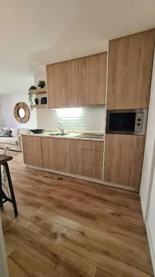 a kitchen with wooden cabinets in a room at Enjoy Porto's Vibes in Porto