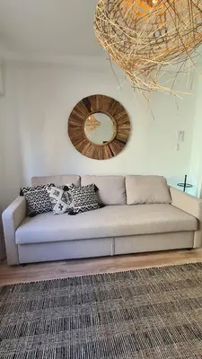a living room with a couch and a mirror on the wall at Enjoy Porto's Vibes in Porto