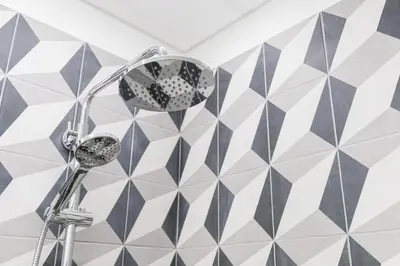a shower in a bathroom with black and white tiles at Cozy Studio-Fast Wi-Fi-Near Campanhã Station & River in Porto