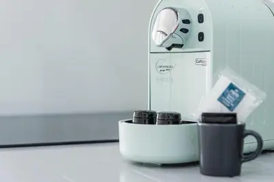 a coffee maker and two cups on a counter at Cozy Studio-Fast Wi-Fi-Near Campanhã Station & River in Porto