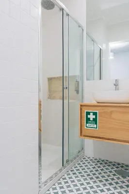 a bathroom with a glass shower and a sink at ORM Padrão Apartment in Porto