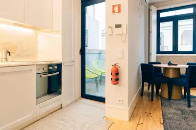 a kitchen and dining room with a table and chairs at ORM Padrão Apartment in Porto
