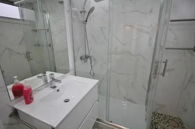 a bathroom with a white sink and a shower at HEART OF THE CITY 8! in Vila Nova de Gaia