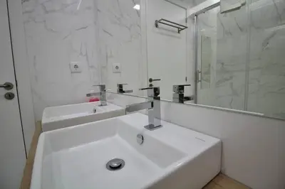 a white bathroom with two sinks and a mirror at HEART OF THE CITY 8! in Vila Nova de Gaia