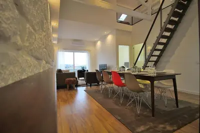 a dining room with a long table and chairs at HEART OF THE CITY 8! in Vila Nova de Gaia