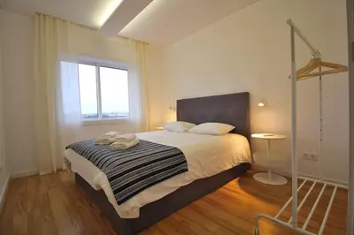 a bedroom with a bed with two towels on it at HEART OF THE CITY 8! in Vila Nova de Gaia