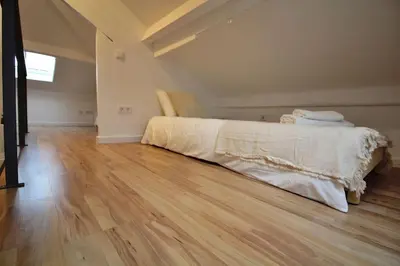 a bedroom with a bed and a wooden floor at HEART OF THE CITY 8! in Vila Nova de Gaia