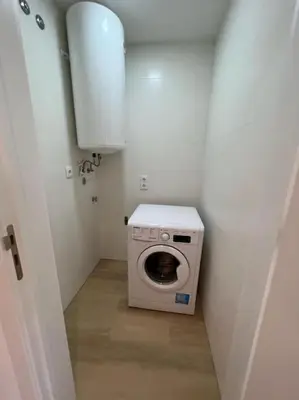 a small bathroom with a washing machine in a room at HEART OF THE CITY 10 ! in Porto