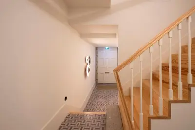 a hallway with stairs and a white door at HM - Infante Riverside Apartment B in Porto