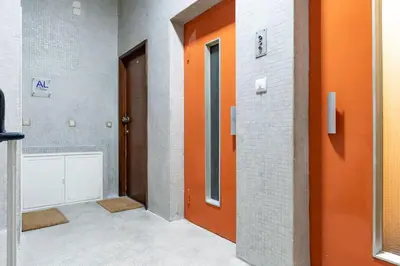 an empty hallway with an orange door in a building at VIVA Marquês Studio in Porto