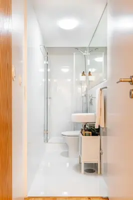 a white bathroom with a sink and a toilet at VIVA Jolicoeur Porto in Porto