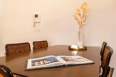 a book on a table with a vase of flowers at VIVA Jolicoeur Porto in Porto