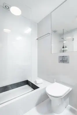 a white bathroom with a toilet and a shower at VIVA Jolicoeur Porto in Porto
