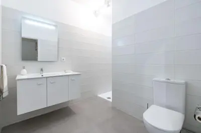 a white bathroom with a toilet and a sink at VIVA Casa do Galo in Porto