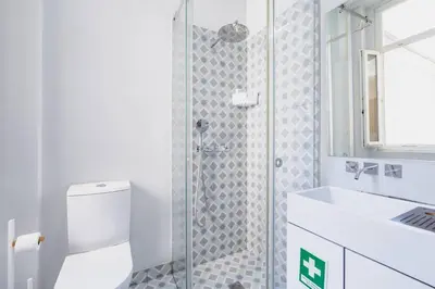a bathroom with a shower and a toilet and a sink at VIVA Arts Cozy Studio in Porto
