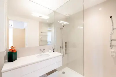 a white bathroom with a sink and a shower at VIVA Nanda's Place in Porto