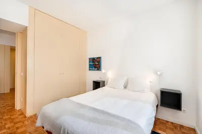 a bedroom with a white bed and a tv at VIVA Nanda's Place in Porto